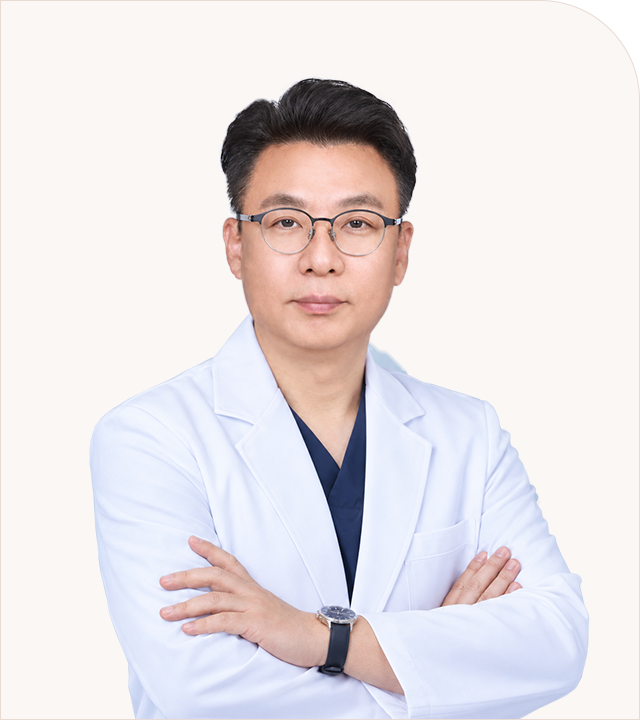 안경과 흰 진료복을 착용하고 팔짱을 낀 미소안의원 박성준 원장